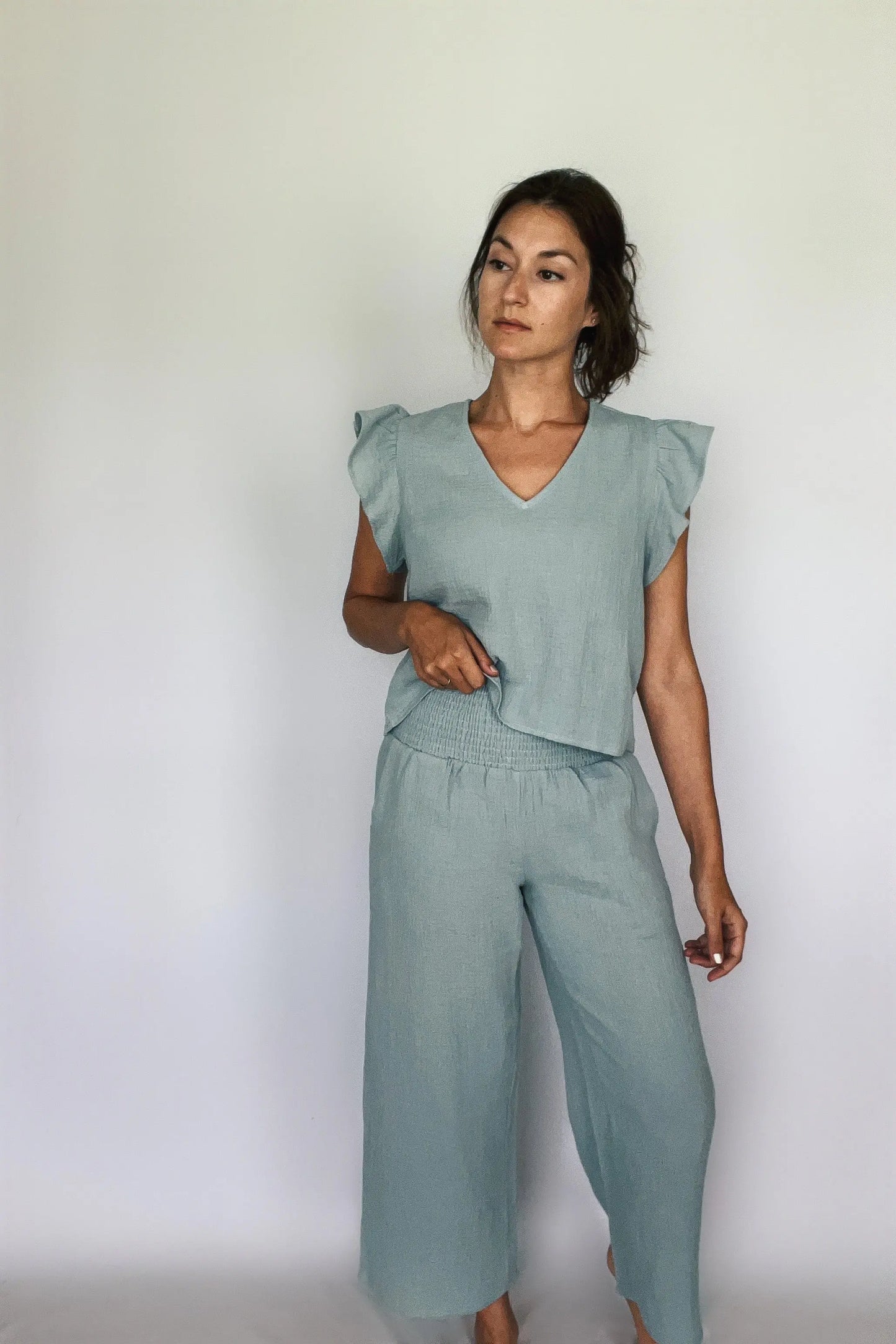 A model showcasing sea blue cotton gauze smocking waist pants paired with matching top