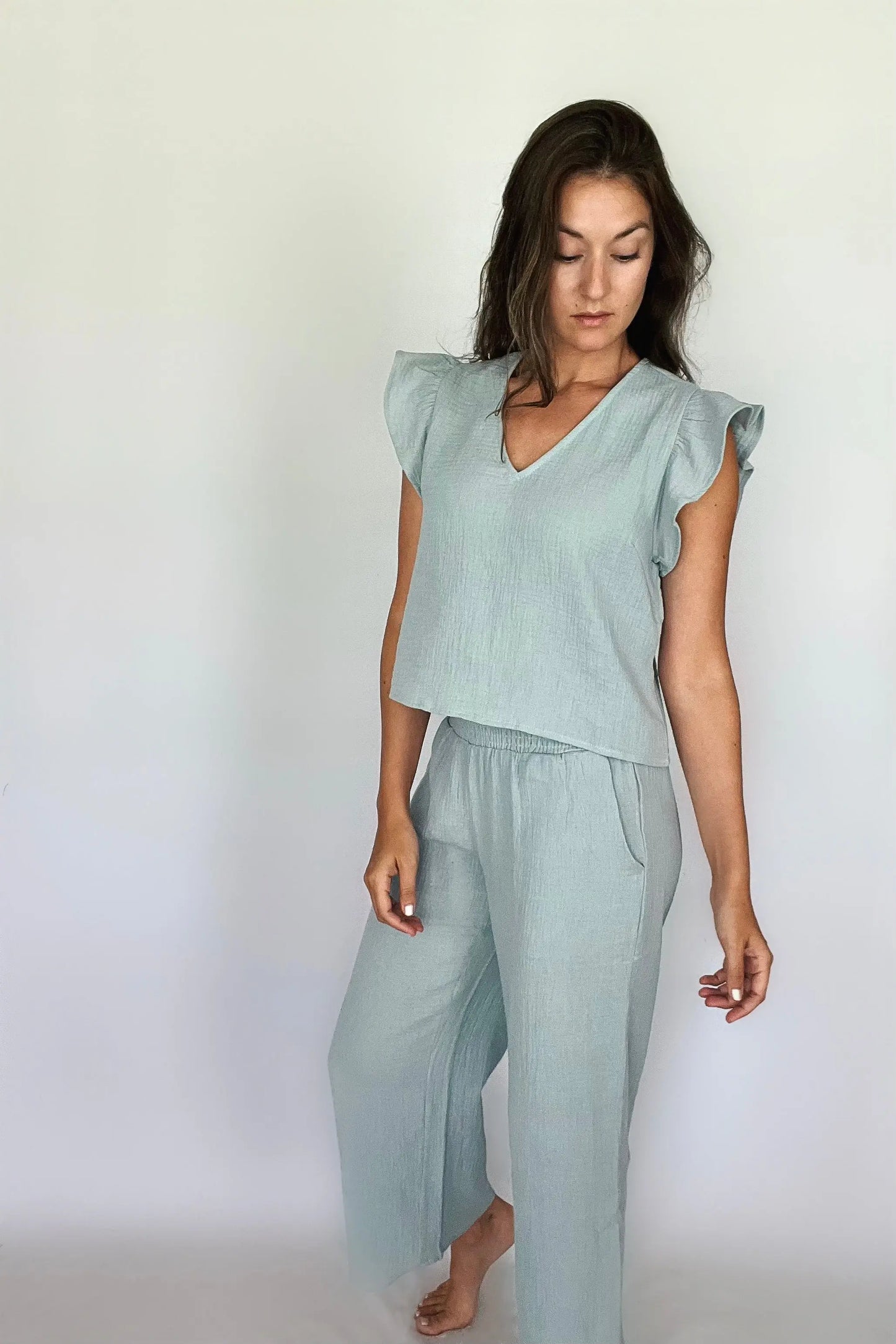 A model showcasing sea blue cotton gauze smocking waist pants paired with matching top