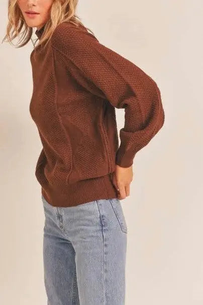 A female modeling the Walnut Mock Neck Pattern Woven Sweater