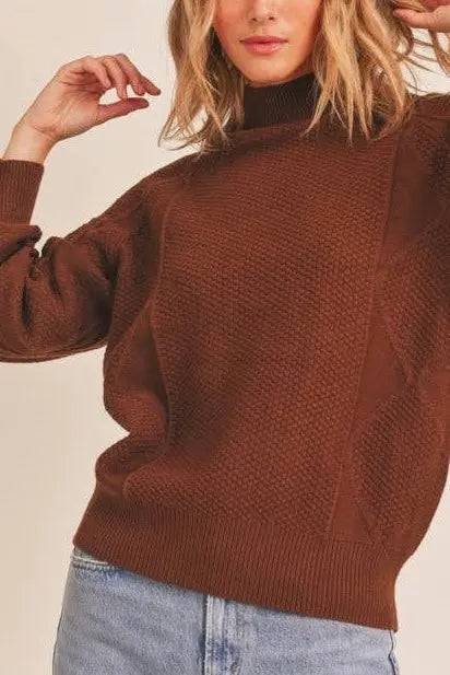 A female modeling the Walnut Mock Neck Pattern Woven Sweater