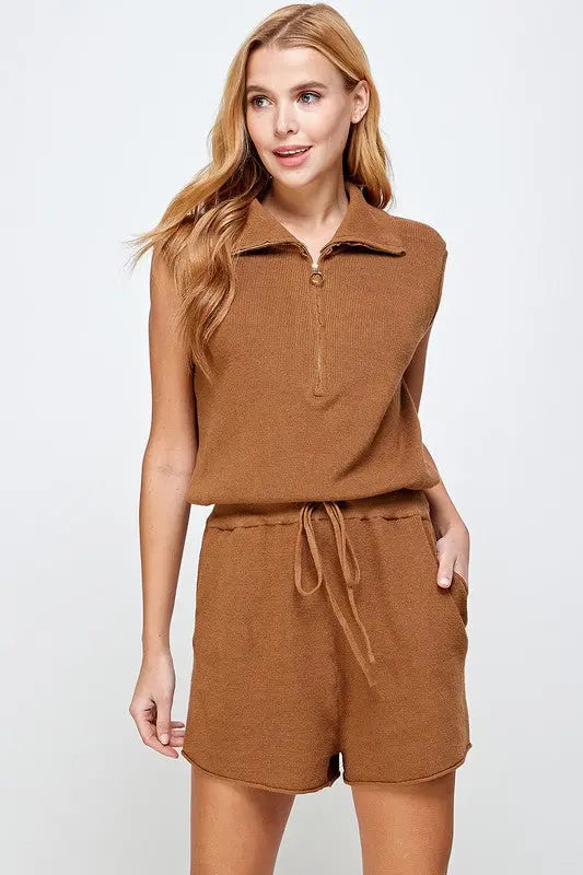 A woman modeling the Camel Half Zip Sleeveless Knit Romper