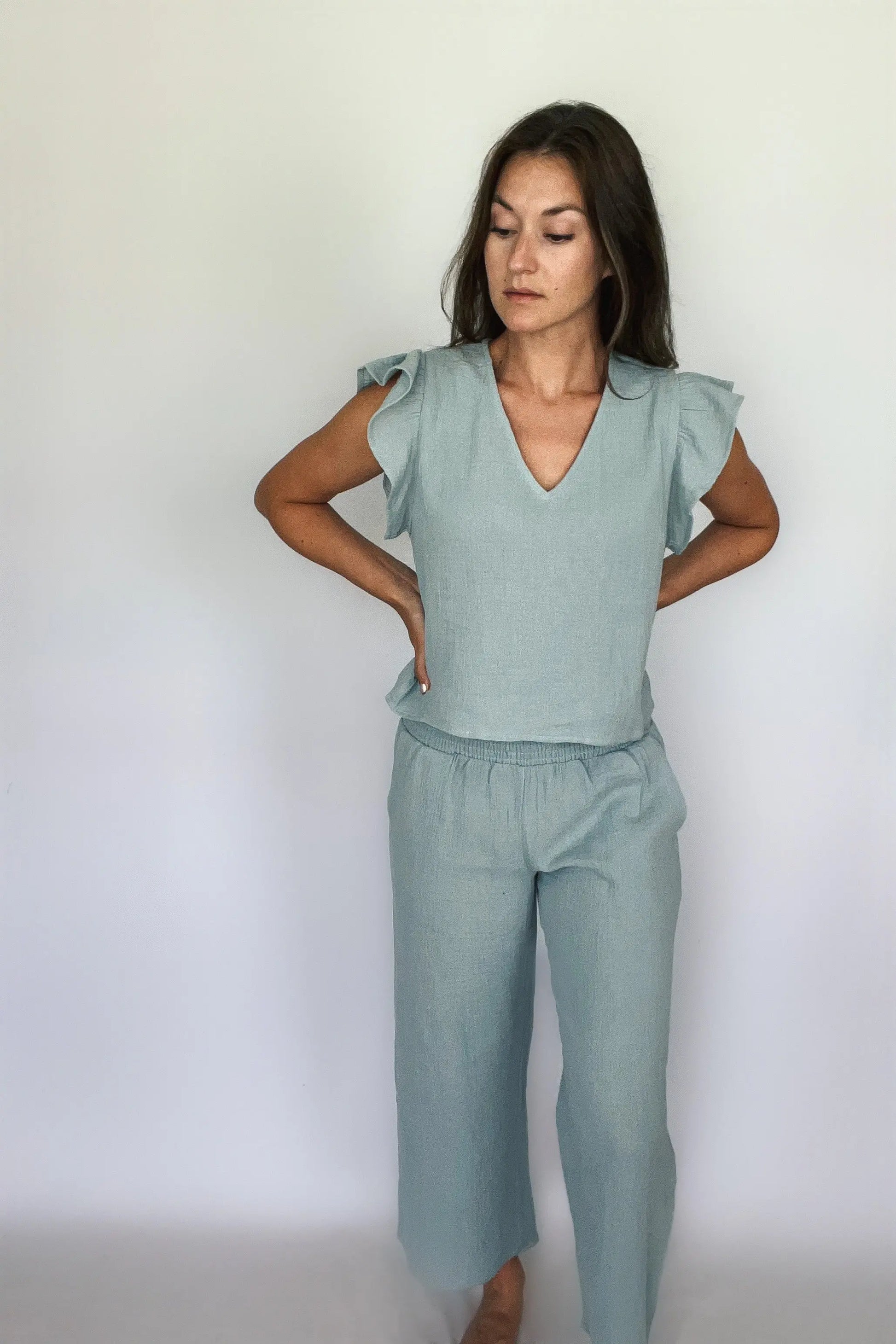 A model showcasing sea blue cotton gauze smocking waist pants paired with matching top