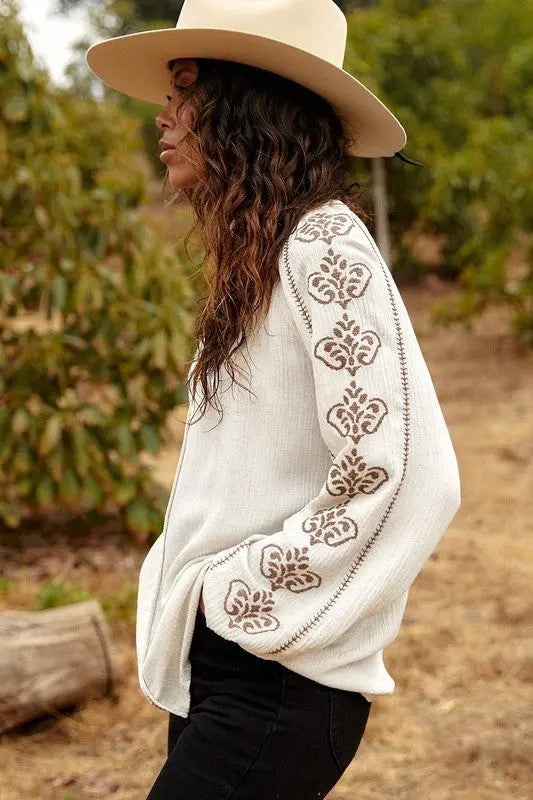 A female model showcasing a Embroidered Long Sleeve Boho Blouse