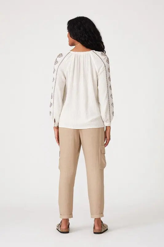 A female model showcasing a Embroidered Long Sleeve Boho Blouse