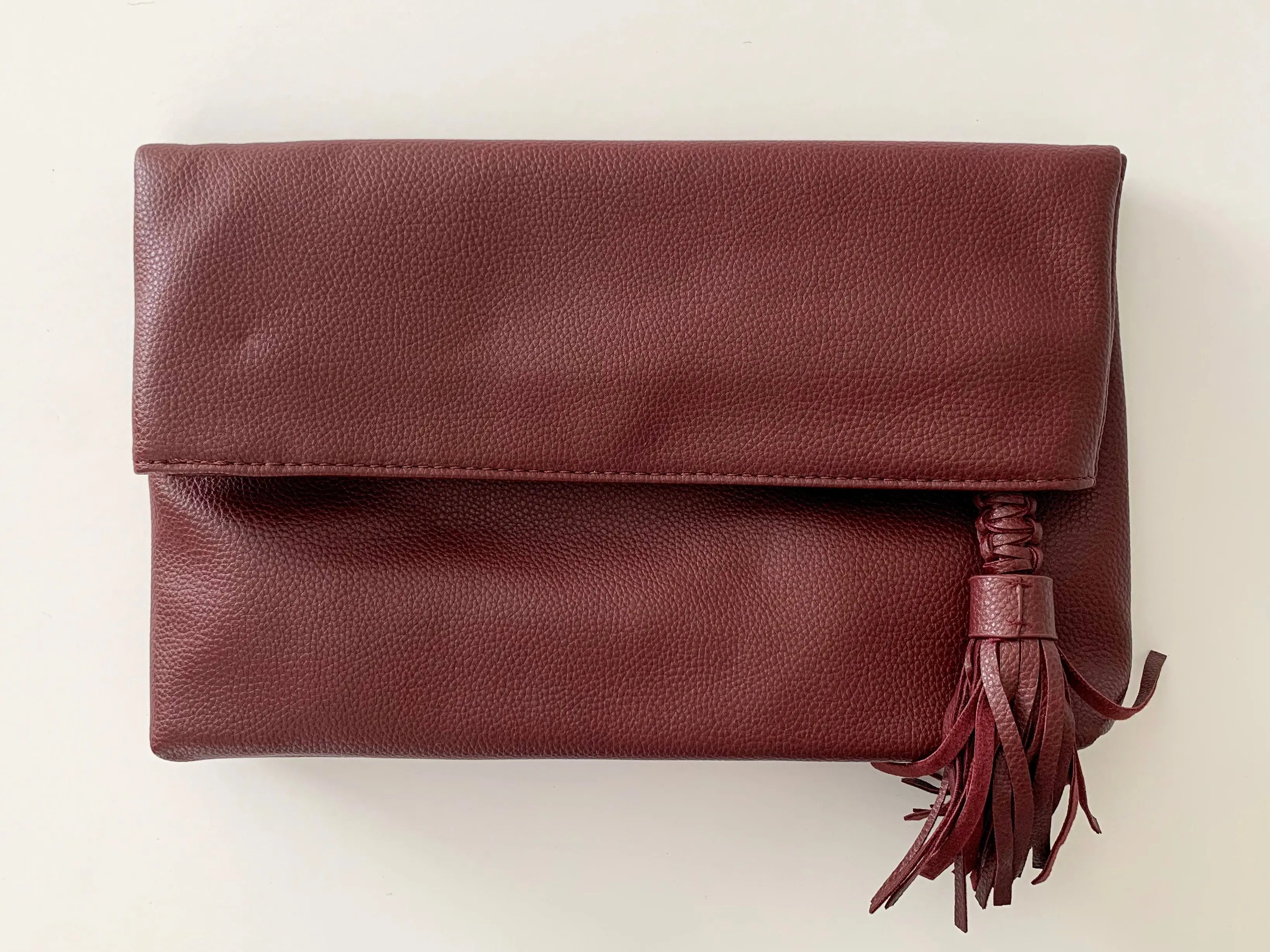 The Tiny Details Burgundy Smooth Folded Tassel Clutch