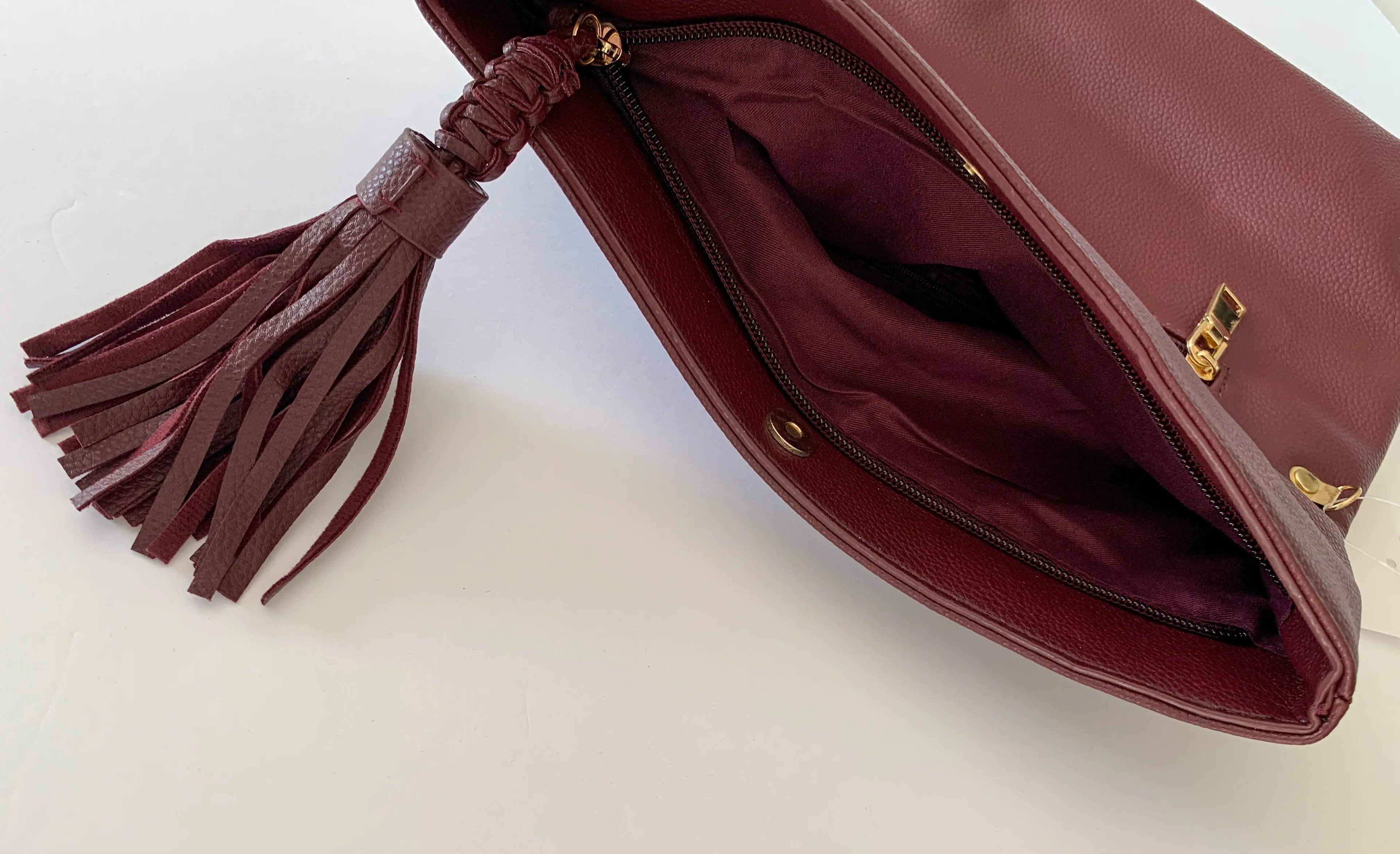 The Tiny Details Burgundy Smooth Folded Tassel Clutch