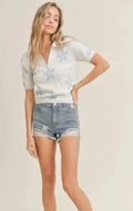 A female modeling the Coastal Cutie Sky Polo Sweater Top
