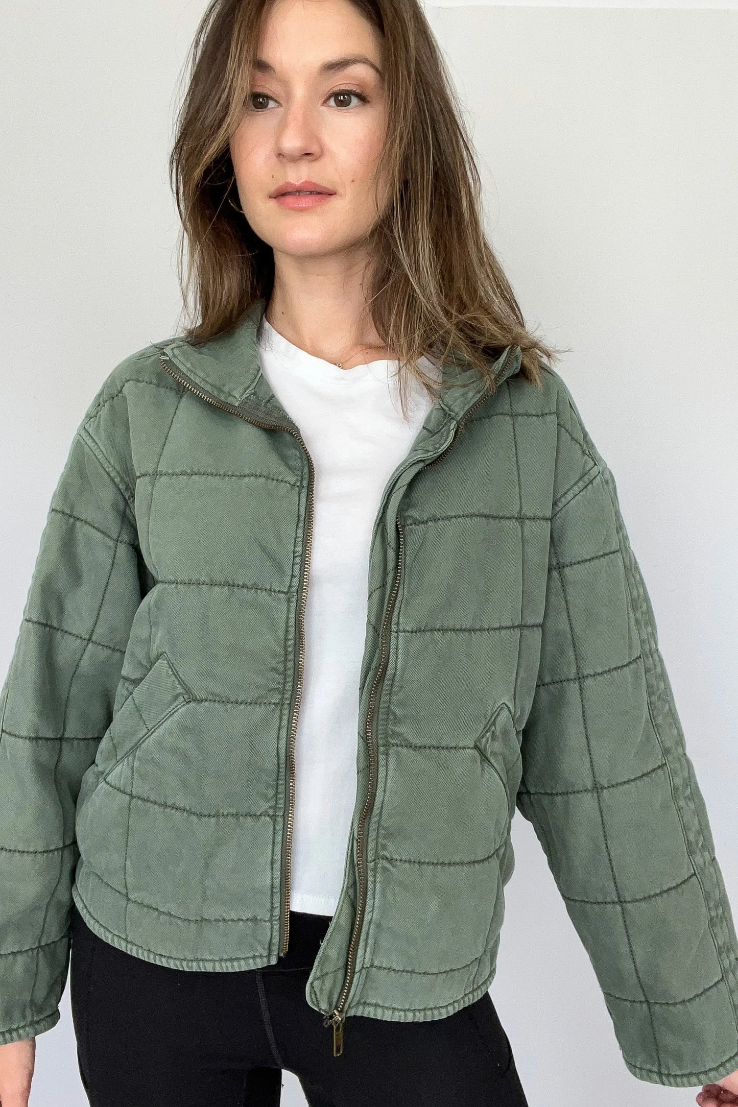 The Tiny Details modeling a Green Dolman Quilted Denim Jacket for women