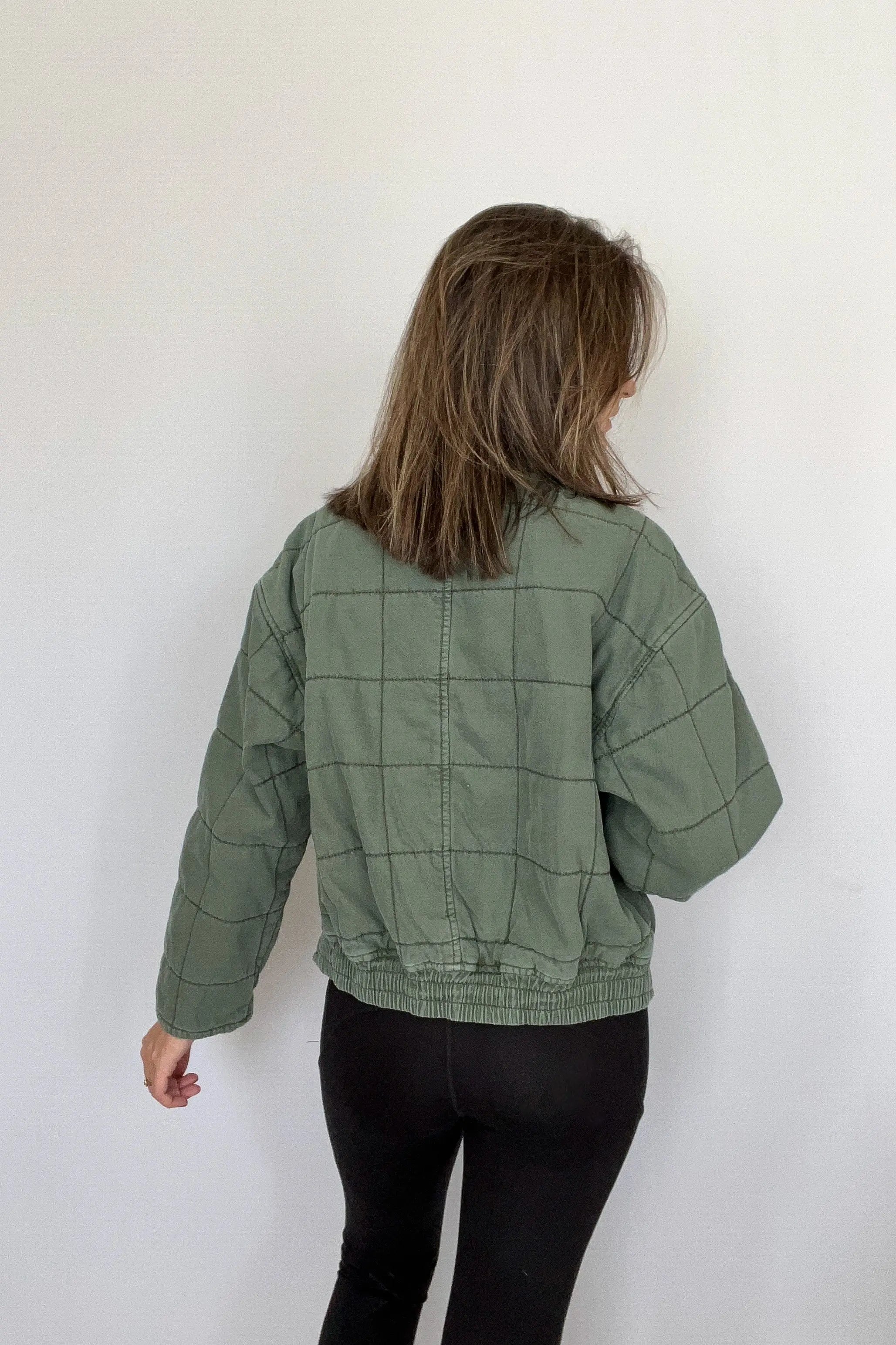 The Tiny Details modeling a Green Dolman Quilted Denim Jacket for women