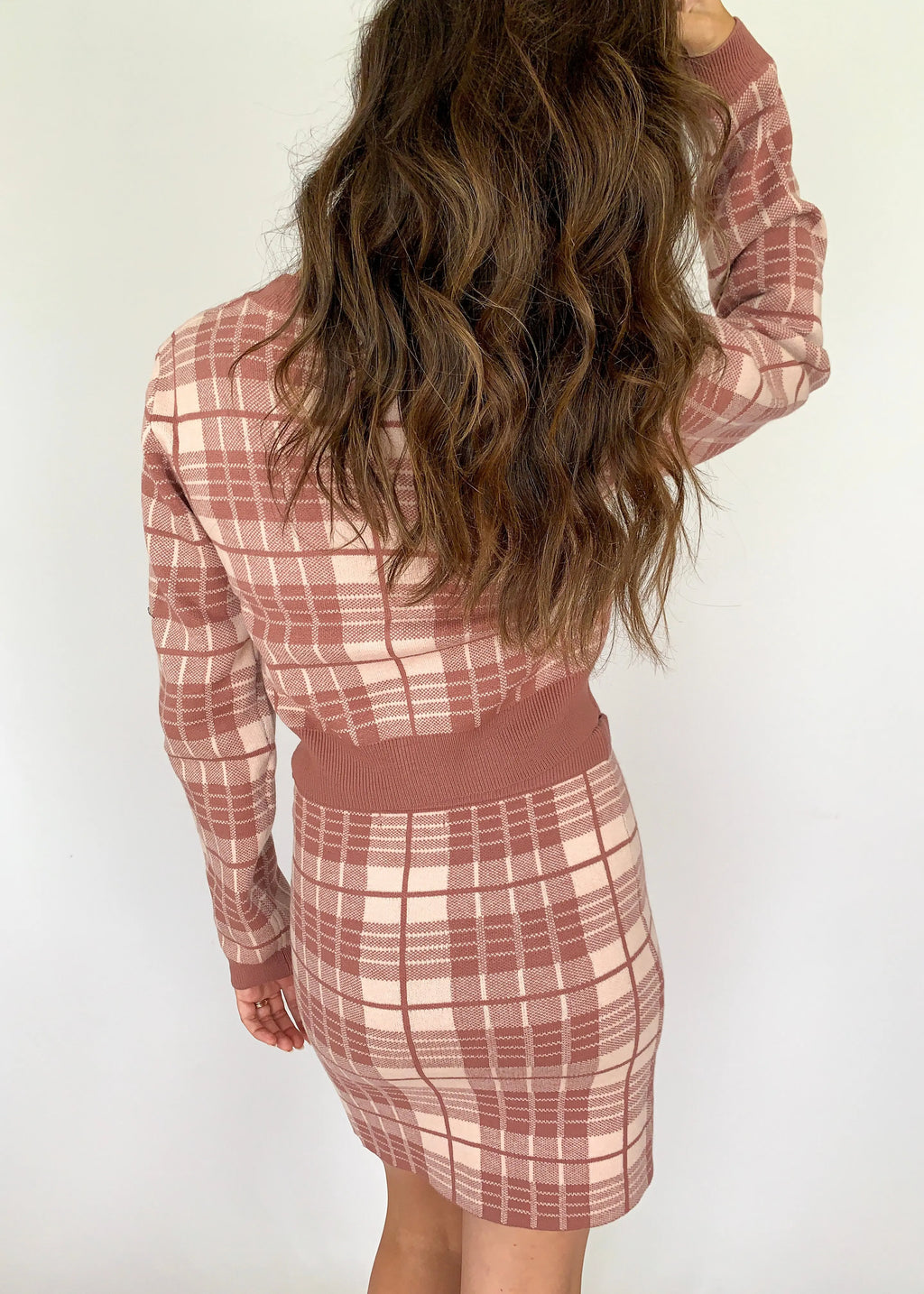 A model showcasing a mauve plaid knit elastic skirt for women