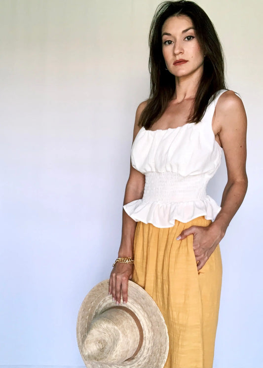 The Tiny Details Off White Sleeveless Smocked Peplum Top