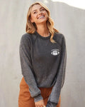 A women modeling the touchdown graphic fleece acid wash pullover