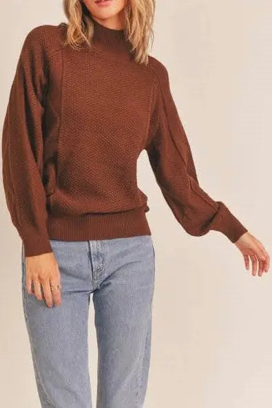 A female modeling the Walnut Mock Neck Pattern Woven Sweater